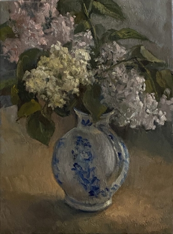 A bouqete of lilacs in a ceramic jug.